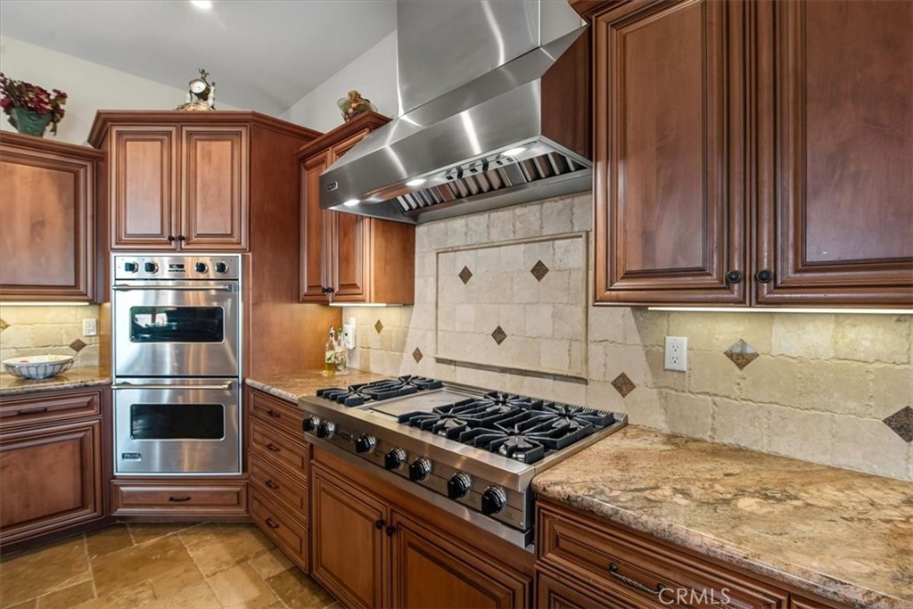 775 Riata Lane Nipomo, CA 93444 - Photo 5 of 48 a kitchen with wooden cabinets and a stove top oven