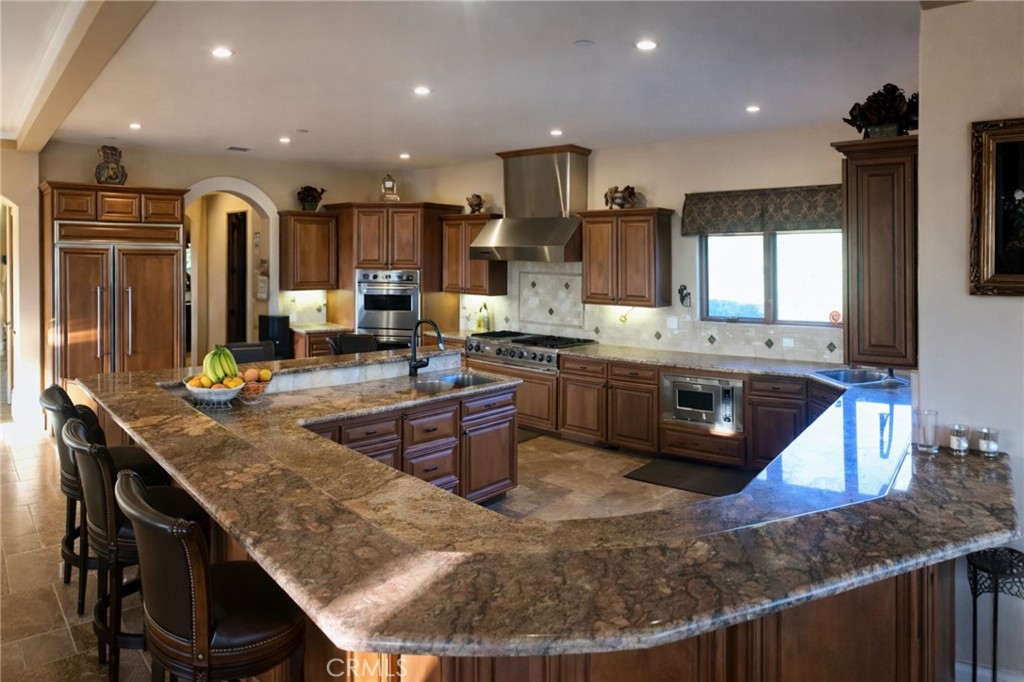 775 Riata Lane Nipomo, CA 93444 - Photo 8 of 40 a kitchen with stainless steel appliances granite countertop a stove a sink and a microwave