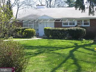 a view of a house with a yard and sitting area
