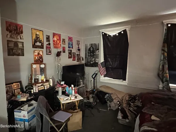 a room with furniture a flat screen tv and a fireplace