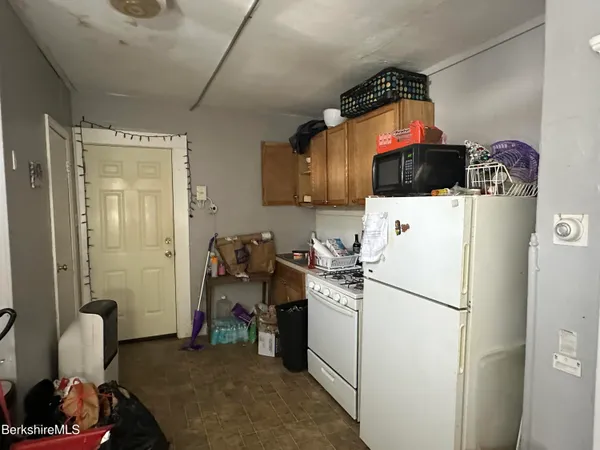 a kitchen with a refrigerator and a washer dryer