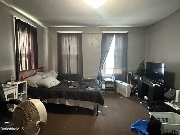 a living room with furniture and floor to ceiling window