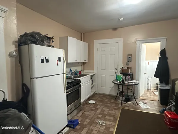 a white refrigerator freezer sitting inside of a kitchen