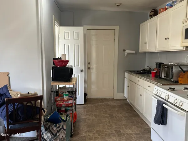 a kitchen with stainless steel appliances a stove a sink and a refrigerator