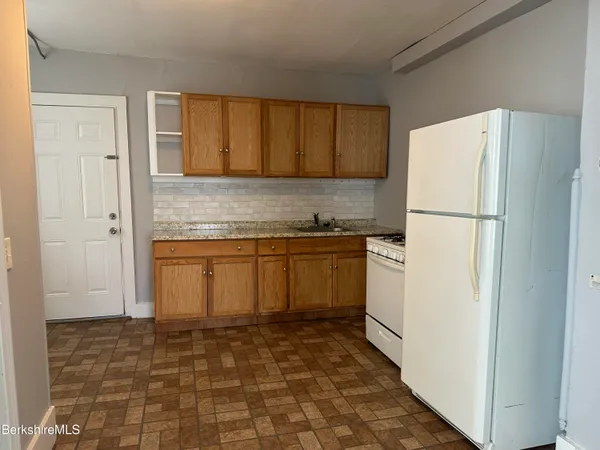 a white refrigerator freezer sitting inside of a kitchen