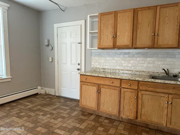 a view of a kitchen with granite countertop cabinets