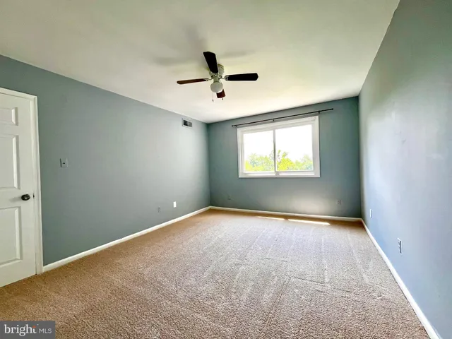 an empty room with closet and wooden door