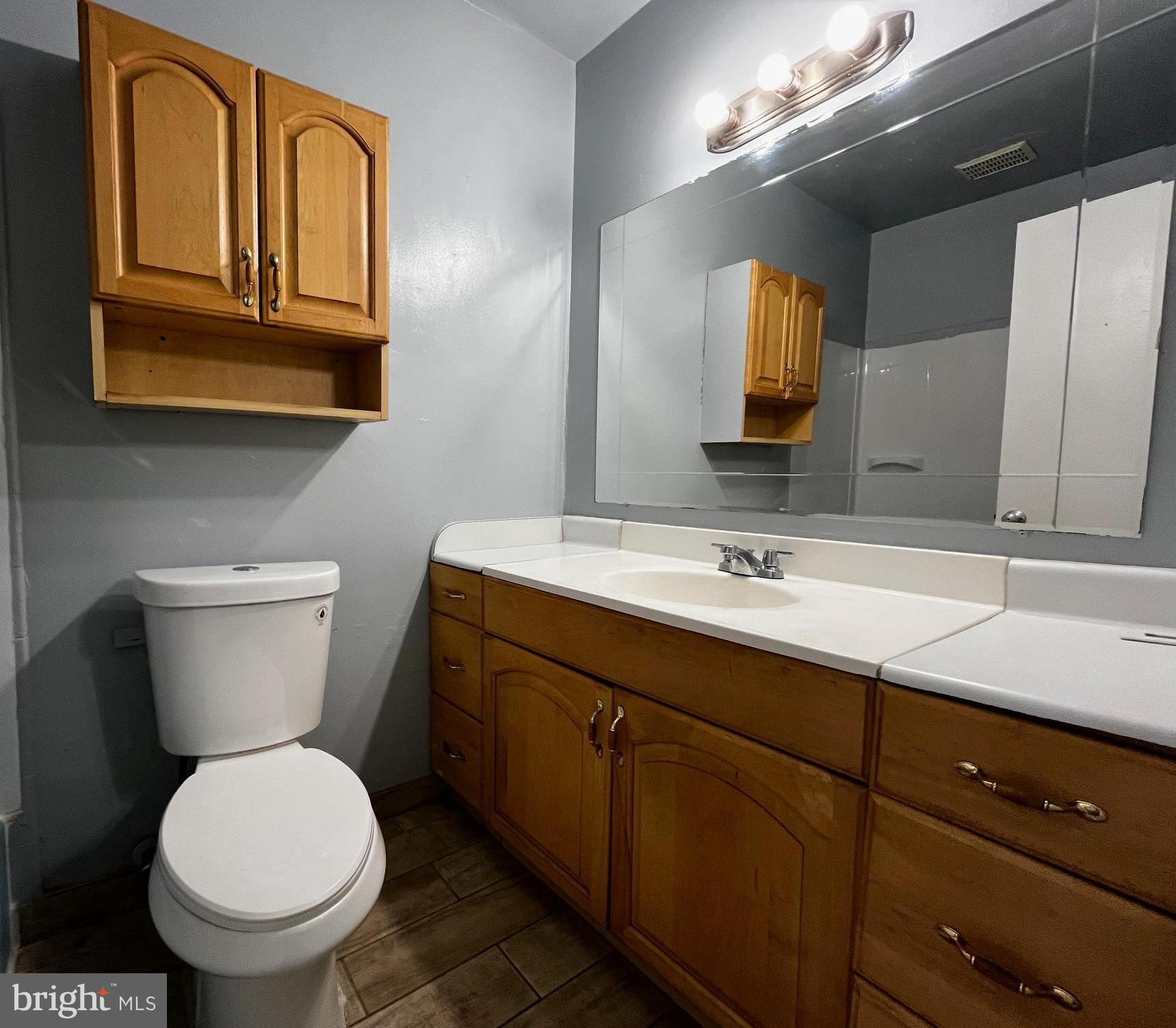 3138 Brinkley Road, Unit 8303 Temple Hills, MD 20748 - Photo 17 of 18 a bathroom with a toilet sink and mirror