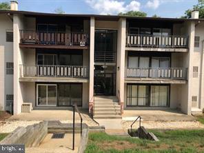 3138 Brinkley Road, Unit 8303 Temple Hills, MD 20748 - Photo 2 of 18 a front view of a house with a yard