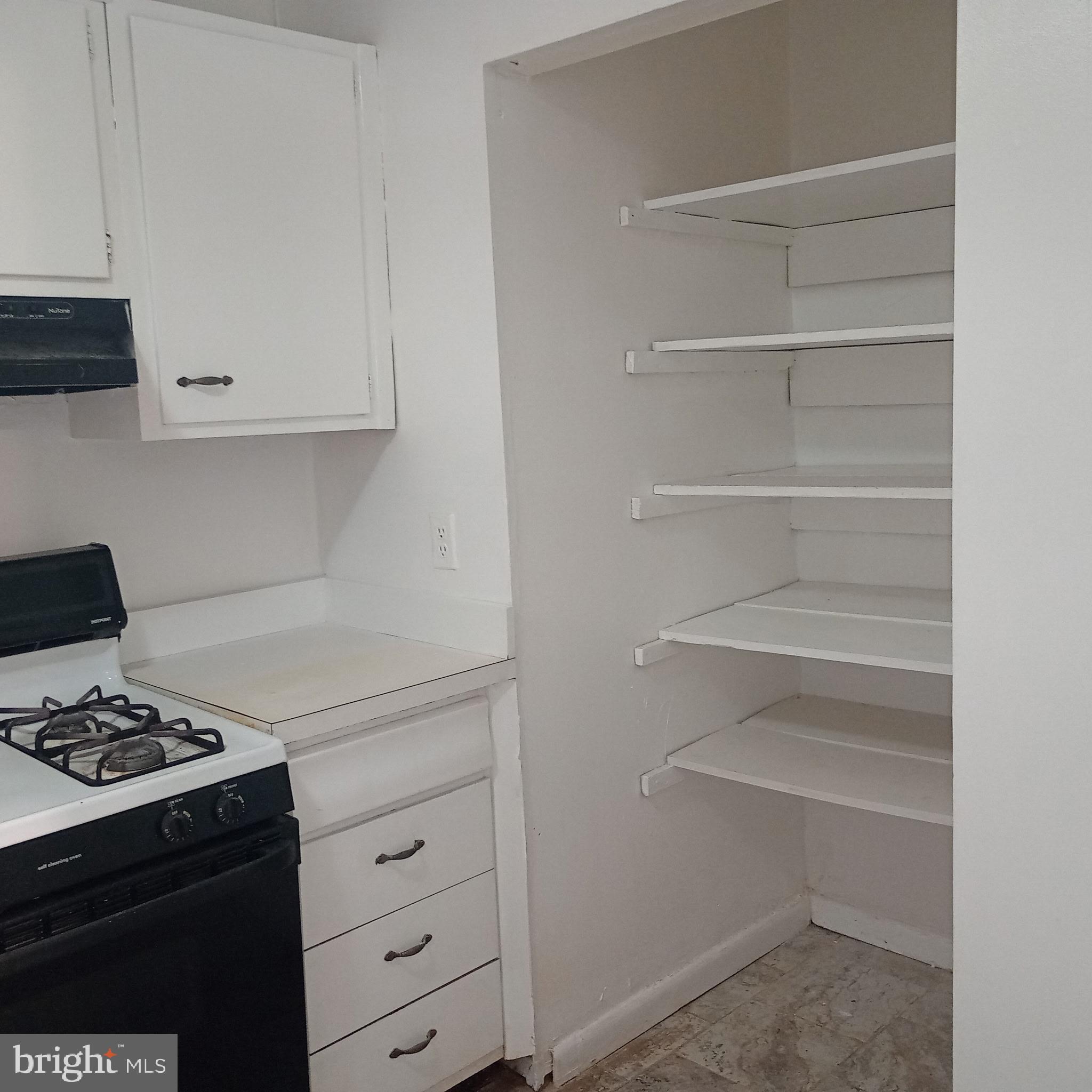 3138 Brinkley Road, Unit 8303 Temple Hills, MD 20748 - Photo 8 of 18 a kitchen with white cabinets and appliances