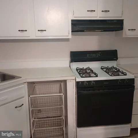 a stove top oven sitting inside of a kitchen