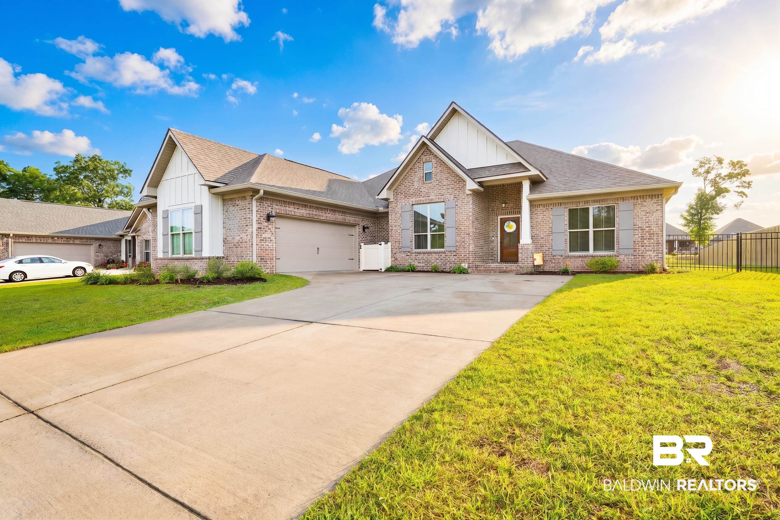 12672 Squirrel Drive Daphne, AL 36527 - Photo 1 of 49 Brick facade residence featuring a covered front entry, gabled rooflines, a two-car garage, and a concrete driveway