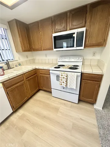 a kitchen with stainless steel appliances granite countertop a stove microwave and sink