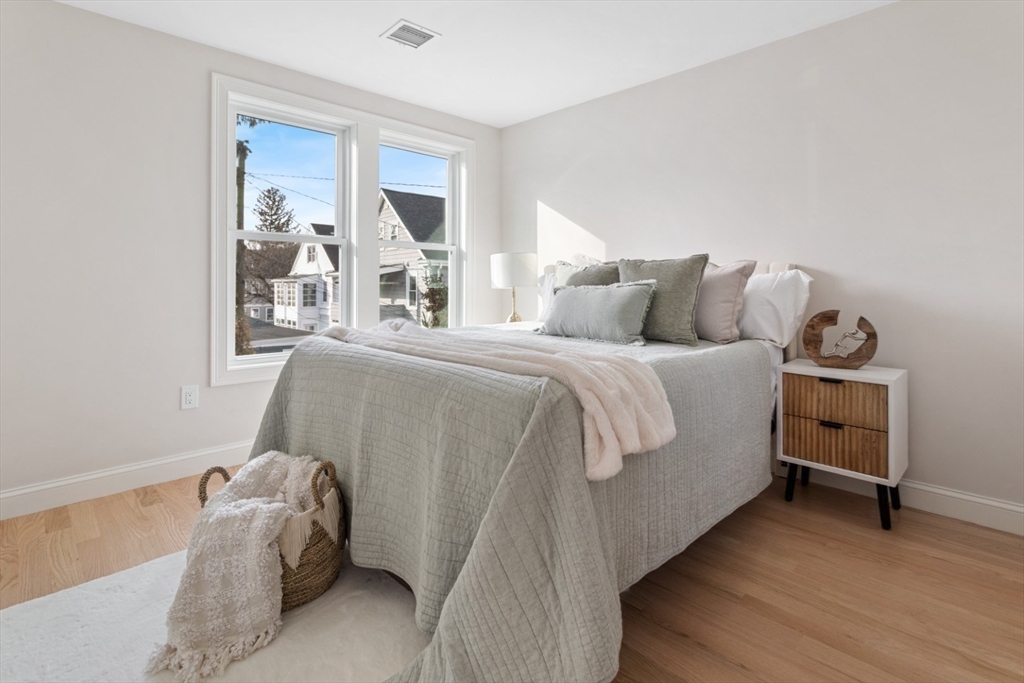 155 A Boston Avenue, Unit 2 Somerville, MA 02144 - Photo 17 of 38 a bedroom with a bed and a window