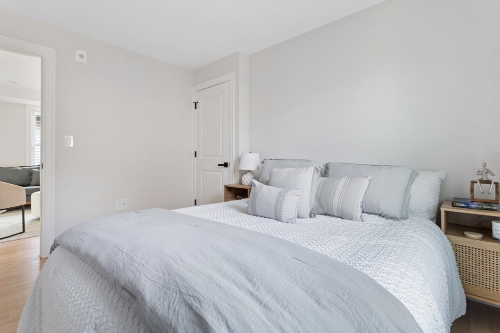 155 A Boston Avenue, Unit 2 Somerville, MA 02144 - Photo 21 of 38 a bedroom with a bed and a couch