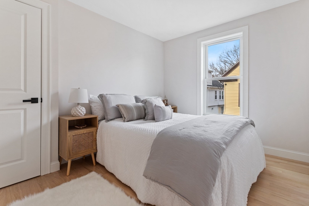 155 A Boston Avenue, Unit 2 Somerville, MA 02144 - Photo 23 of 38 a bedroom with a bed and a window