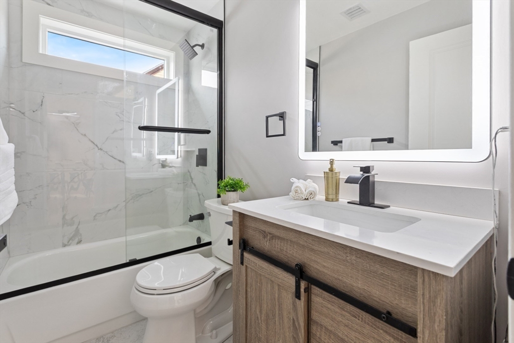 155 A Boston Avenue, Unit 2 Somerville, MA 02144 - Photo 28 of 38 a bathroom with a sink a toilet and shower