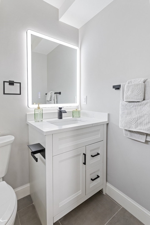 155 A Boston Avenue, Unit 2 Somerville, MA 02144 - Photo 30 of 38 a bathroom with a sink toilet and mirror