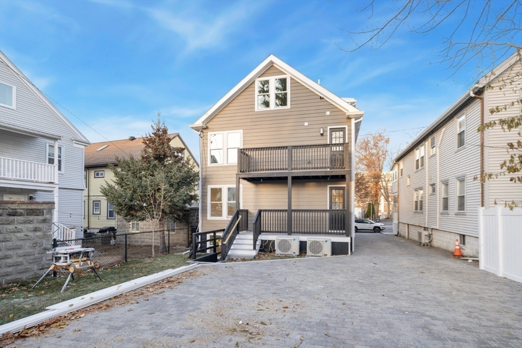 155 A Boston Avenue, Unit 2 Somerville, MA 02144 - Photo 34 of 38 a front view of a house with a yard