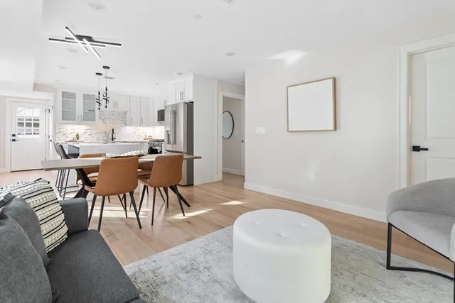 a kitchen with a table chairs refrigerator and cabinets