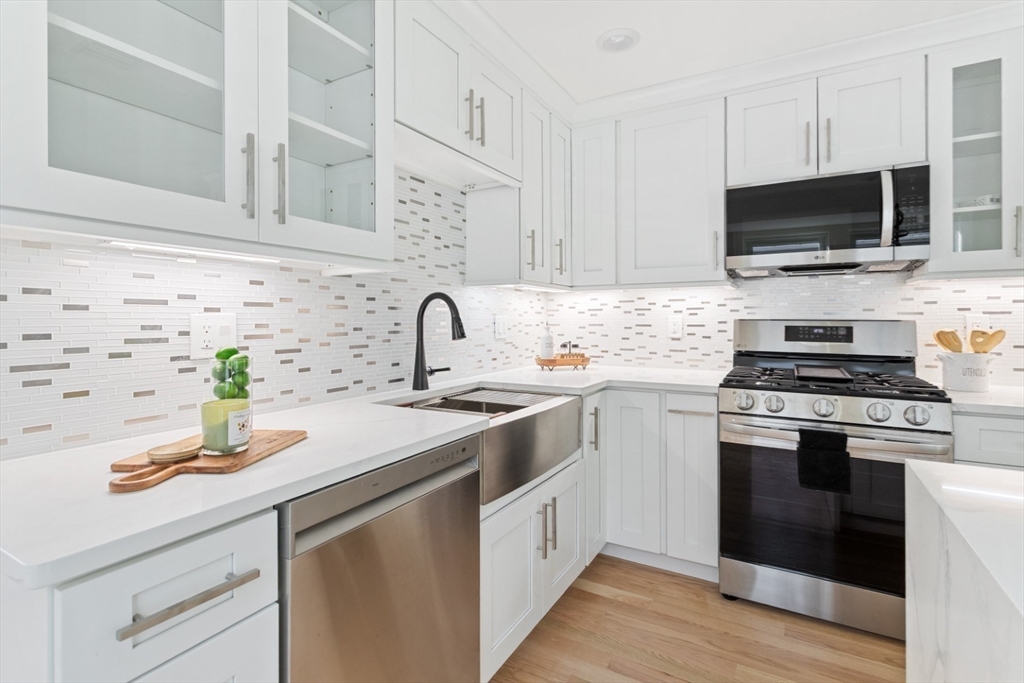 155 A Boston Avenue, Unit 2 Somerville, MA 02144 - Photo 9 of 38 a kitchen with appliances a sink and cabinets