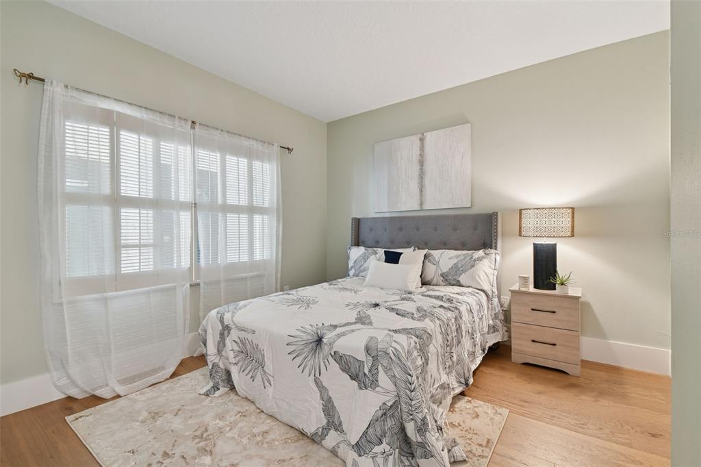 1586 Gulf Boulevard, Unit 2502 Clearwater Beach, FL 33767 - Photo 13 of 47 a bedroom with a bed and a window