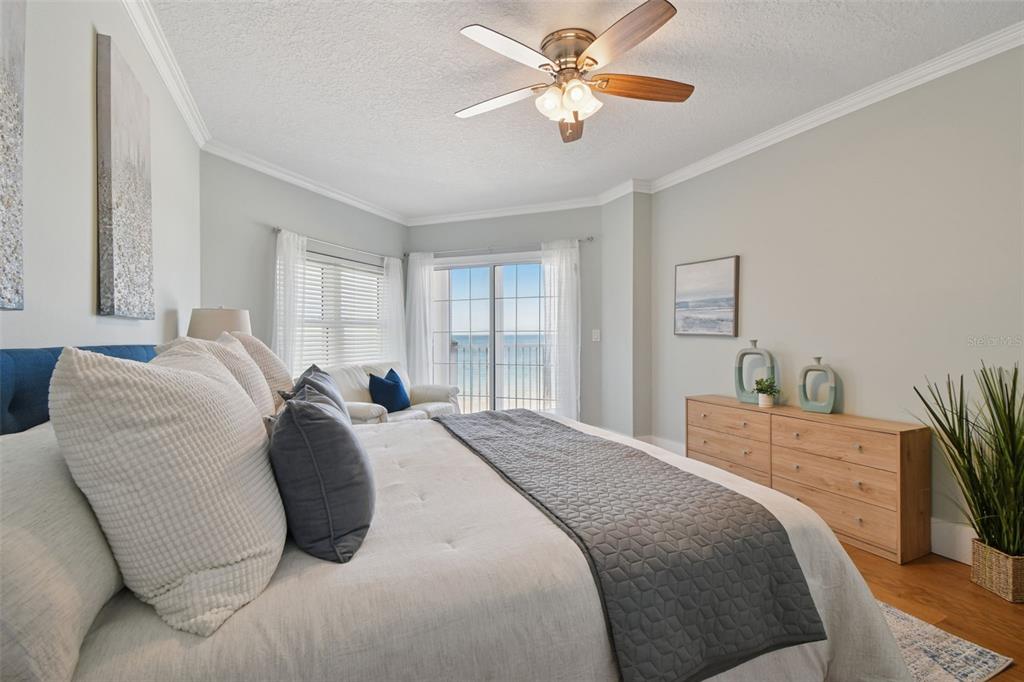 1586 Gulf Boulevard, Unit 2502 Clearwater Beach, FL 33767 - Photo 15 of 47 a bedroom with a bed and a chandelier