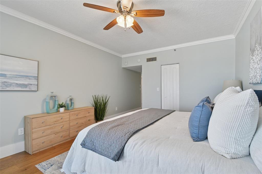 1586 Gulf Boulevard, Unit 2502 Clearwater Beach, FL 33767 - Photo 16 of 47 a bedroom with a bed and a chandelier