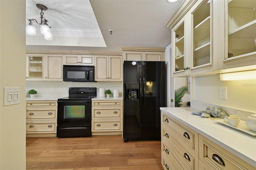 1586 Gulf Boulevard, Unit 2502 Clearwater Beach, FL 33767 - Photo 19 of 47 a kitchen with stainless steel appliances a stove microwave and refrigerator