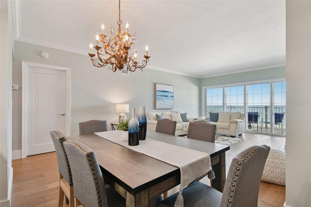 1586 Gulf Boulevard, Unit 2502 Clearwater Beach, FL 33767 - Photo 24 of 47 a view of a dining room with furniture window and wooden floor