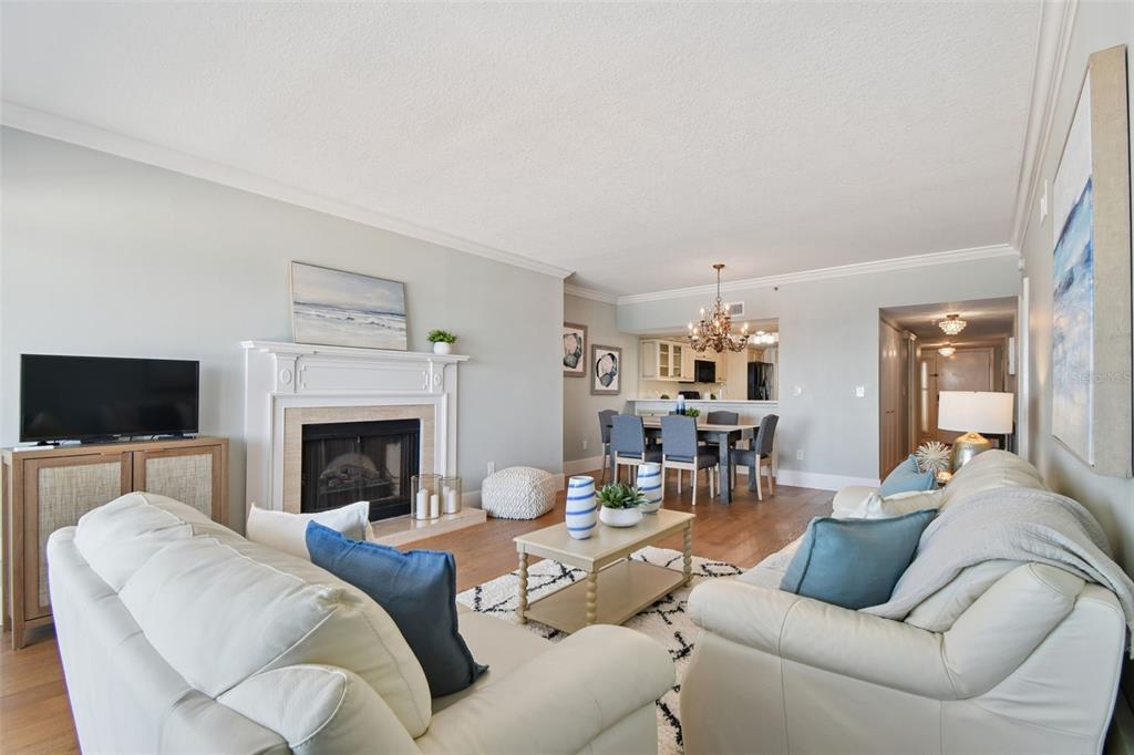 1586 Gulf Boulevard, Unit 2502 Clearwater Beach, FL 33767 - Photo 25 of 47 a living room with furniture a flat screen tv and a fireplace