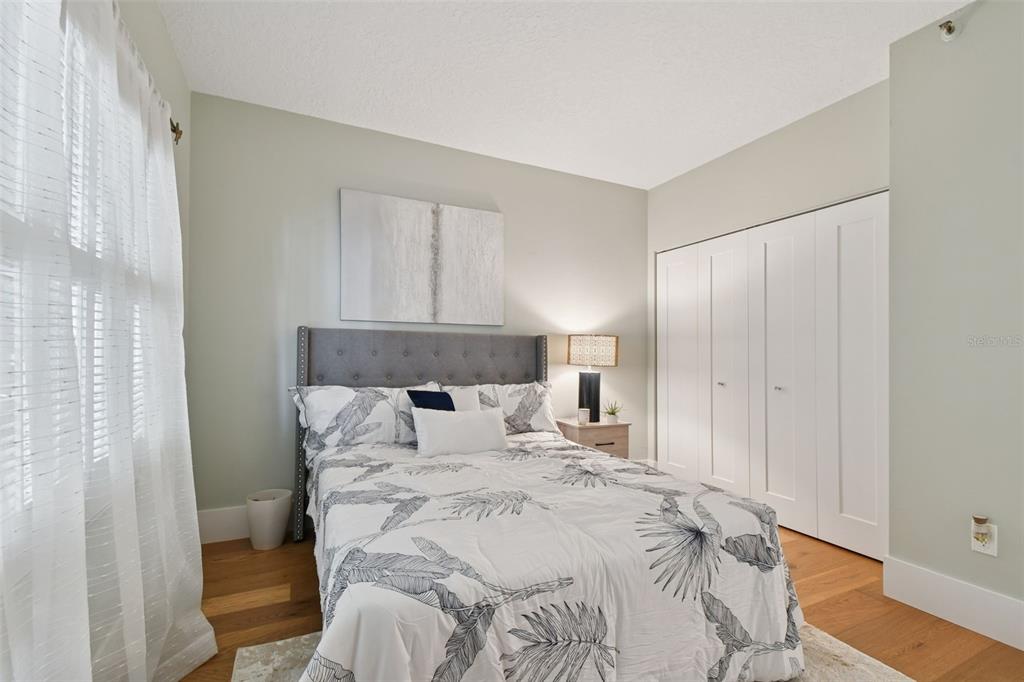 1586 Gulf Boulevard, Unit 2502 Clearwater Beach, FL 33767 - Photo 29 of 47 a large bed sitting in a bedroom next to a window