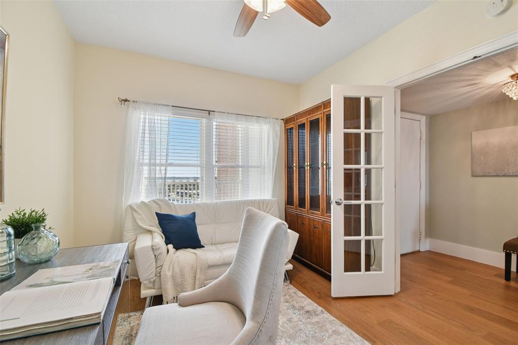 1586 Gulf Boulevard, Unit 2502 Clearwater Beach, FL 33767 - Photo 34 of 47 a view of a dining room with furniture window and wooden floor