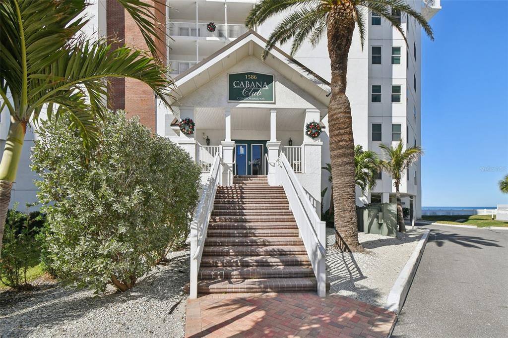 1586 Gulf Boulevard, Unit 2502 Clearwater Beach, FL 33767 - Photo 36 of 47 a view of a tall building with a tree in front