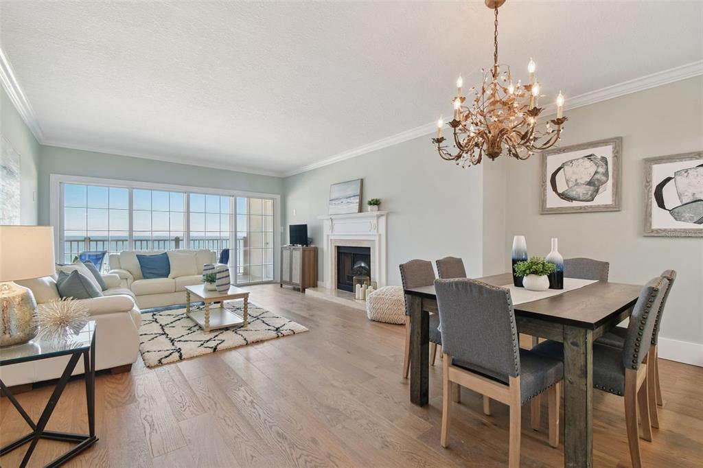 1586 Gulf Boulevard, Unit 2502 Clearwater Beach, FL 33767 - Photo 5 of 47 a living room with furniture and a fireplace