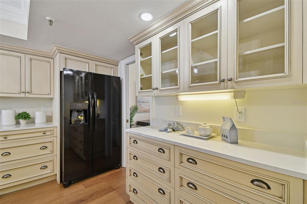 1586 Gulf Boulevard, Unit 2502 Clearwater Beach, FL 33767 - Photo 6 of 47 a kitchen with a refrigerator and a cabinets