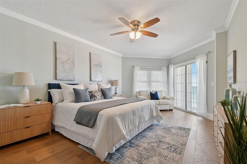 1586 Gulf Boulevard, Unit 2502 Clearwater Beach, FL 33767 - Photo 7 of 47 a bedroom with a large bed and a chandelier