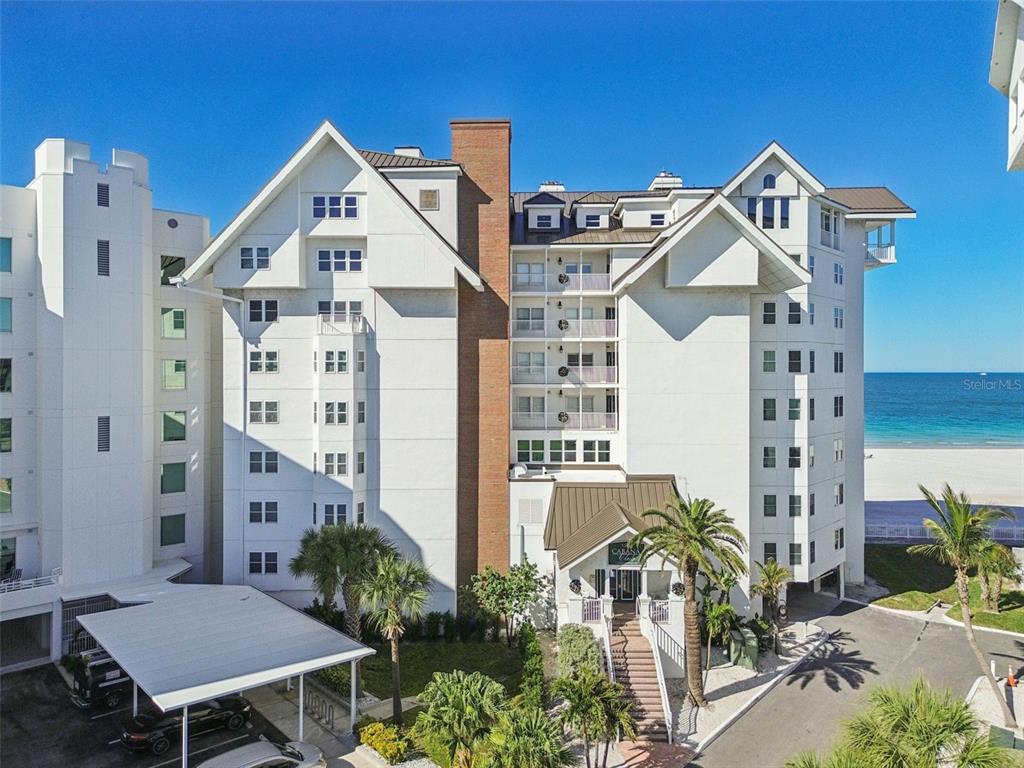 1586 Gulf Boulevard, Unit 2502 Clearwater Beach, FL 33767 - Photo 10 of 47 a view of a big yard with plants and wooden fence