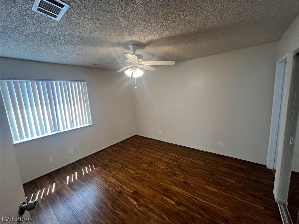 914 Scarlet Ridge Drive Las Vegas, NV 89128 - Photo 22 of 25 Rich hardwood floors and a ceiling fan create a comfortable ambiance in this inviting room.