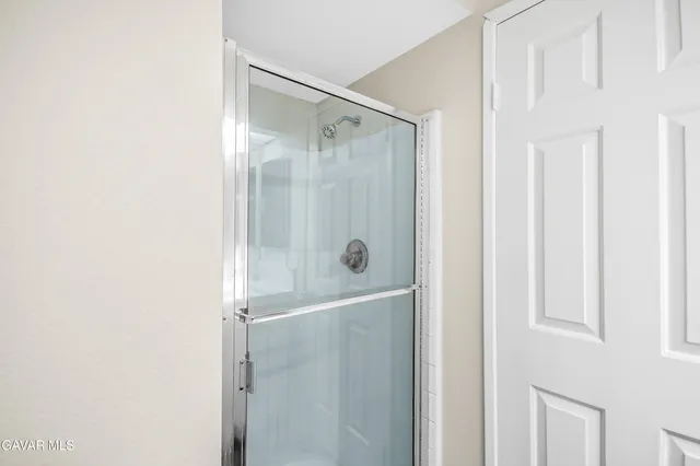 a bathroom with a glass shower door
