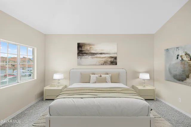 a bedroom with a bed and a large window