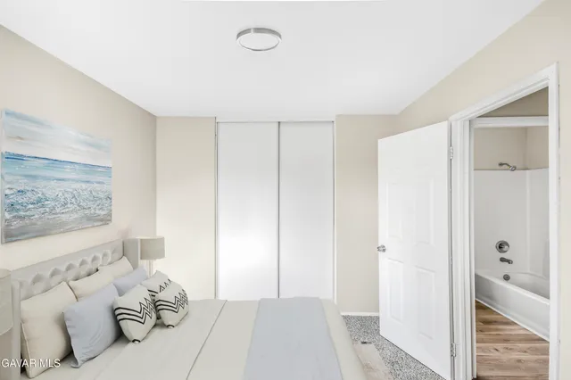 a bedroom with a bed and a couch