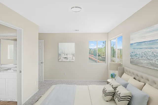 a bedroom with furniture and a window