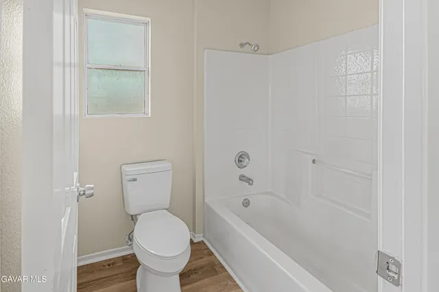 a bathroom with a toilet and a bathtub