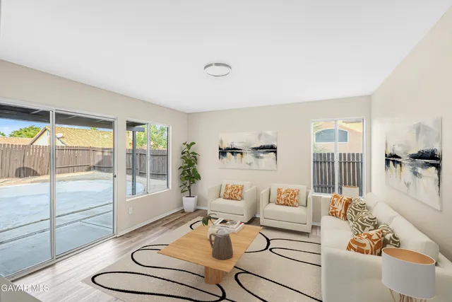 a living room with furniture and a floor to ceiling window