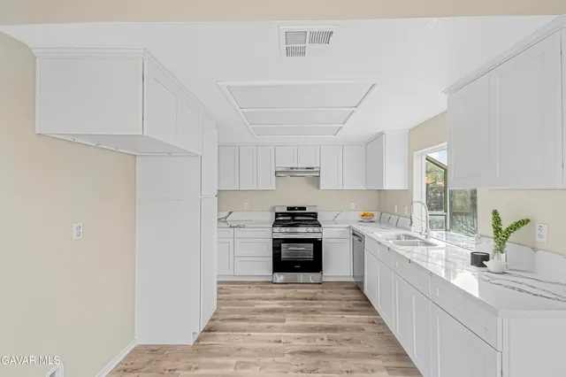 a large kitchen with a stove and cabinets
