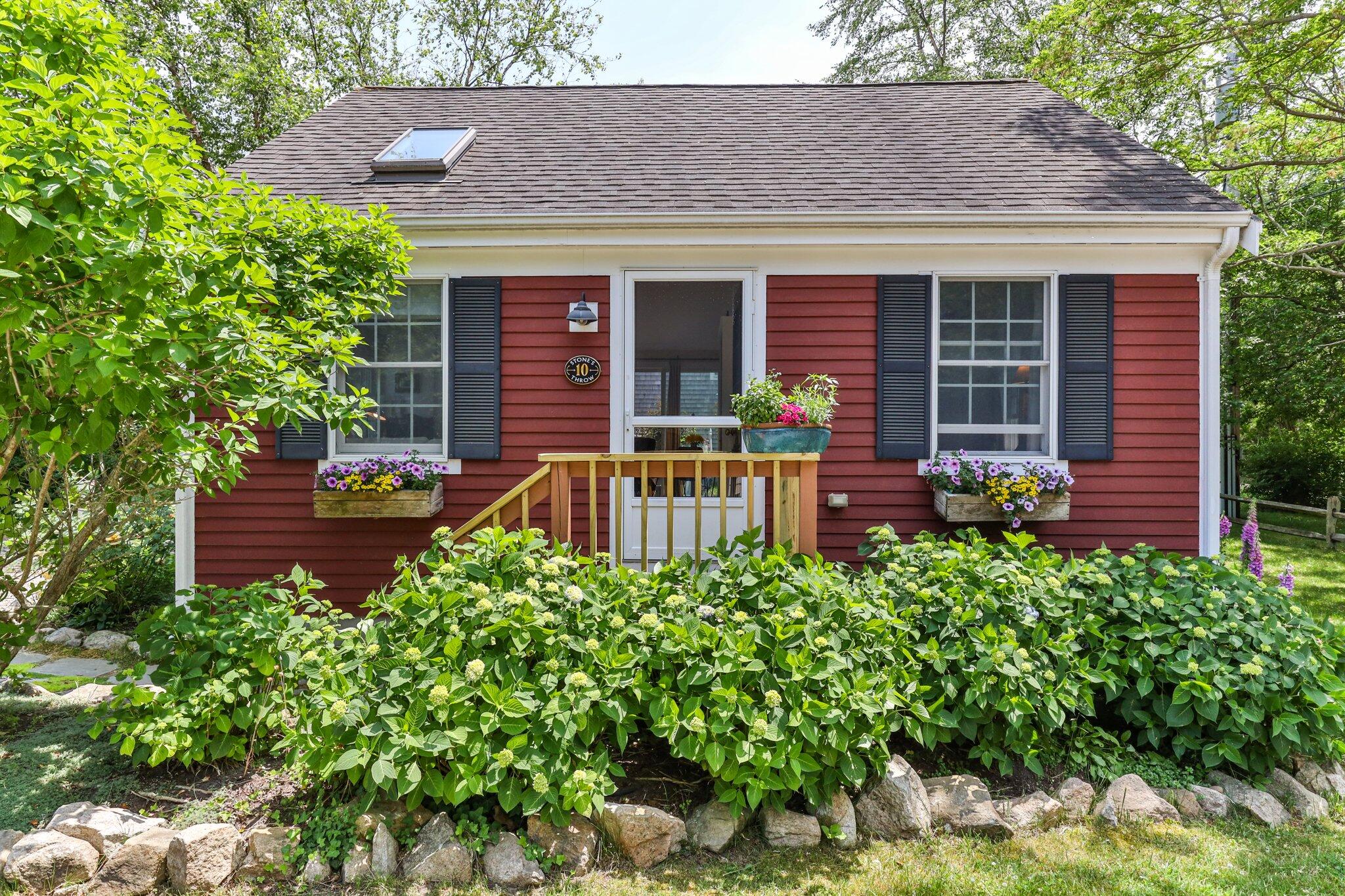 6 Shore Road, Unit 10 Truro, MA 02666 - Photo 1 of 37 front view of a house with a small yard