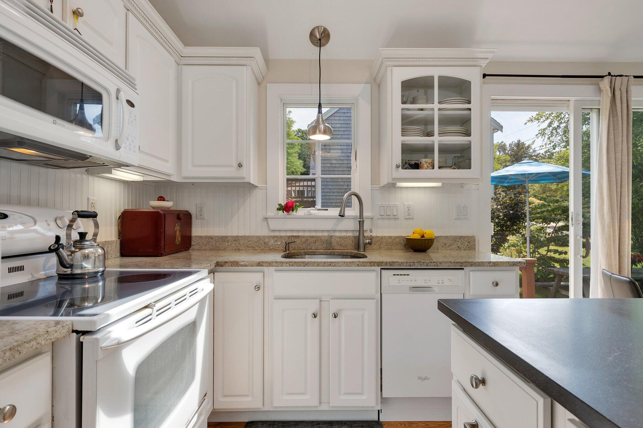 6 Shore Road, Unit 10 Truro, MA 02666 - Photo 12 of 37 a kitchen with cabinets appliances a sink and a window