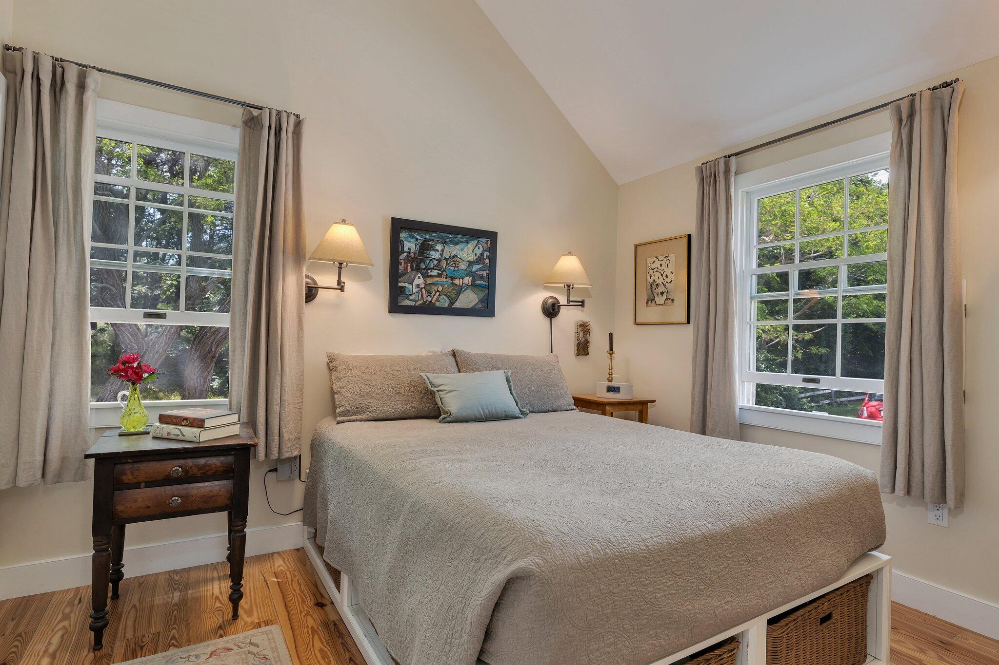 6 Shore Road, Unit 10 Truro, MA 02666 - Photo 14 of 37 a bedroom with a bed table and a window