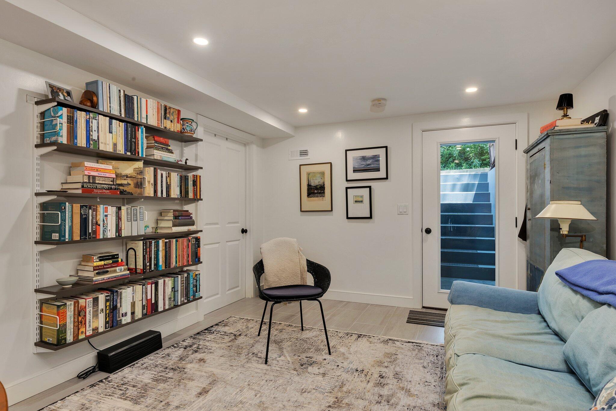 6 Shore Road, Unit 10 Truro, MA 02666 - Photo 19 of 37 a living room with furniture and a book shelf